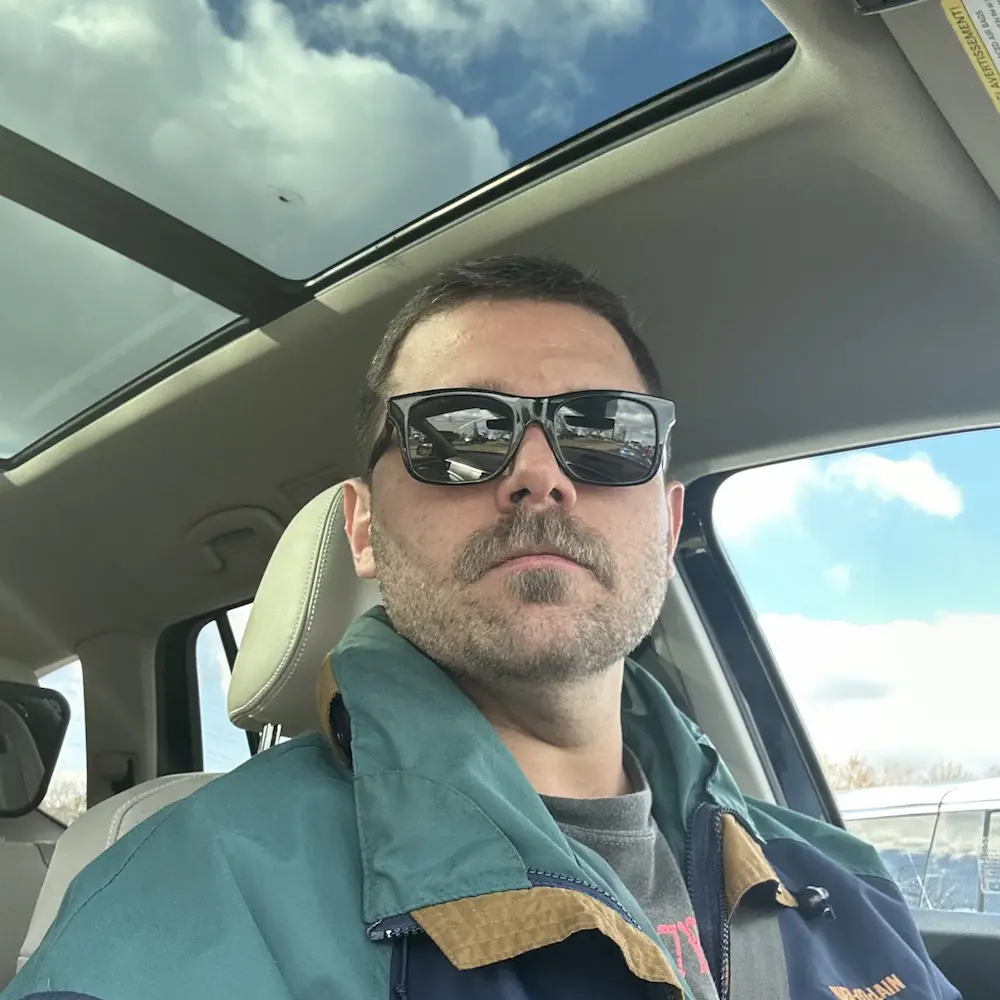 Home a low angle, outdoor selfie taken by a man from inside a car